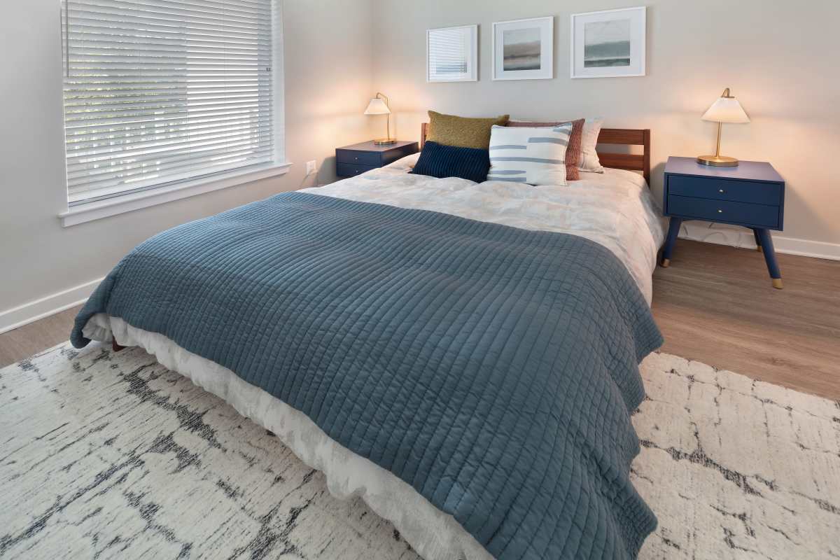Cozy bed with large window and night stand at The Blake in Alexandria, Virginia