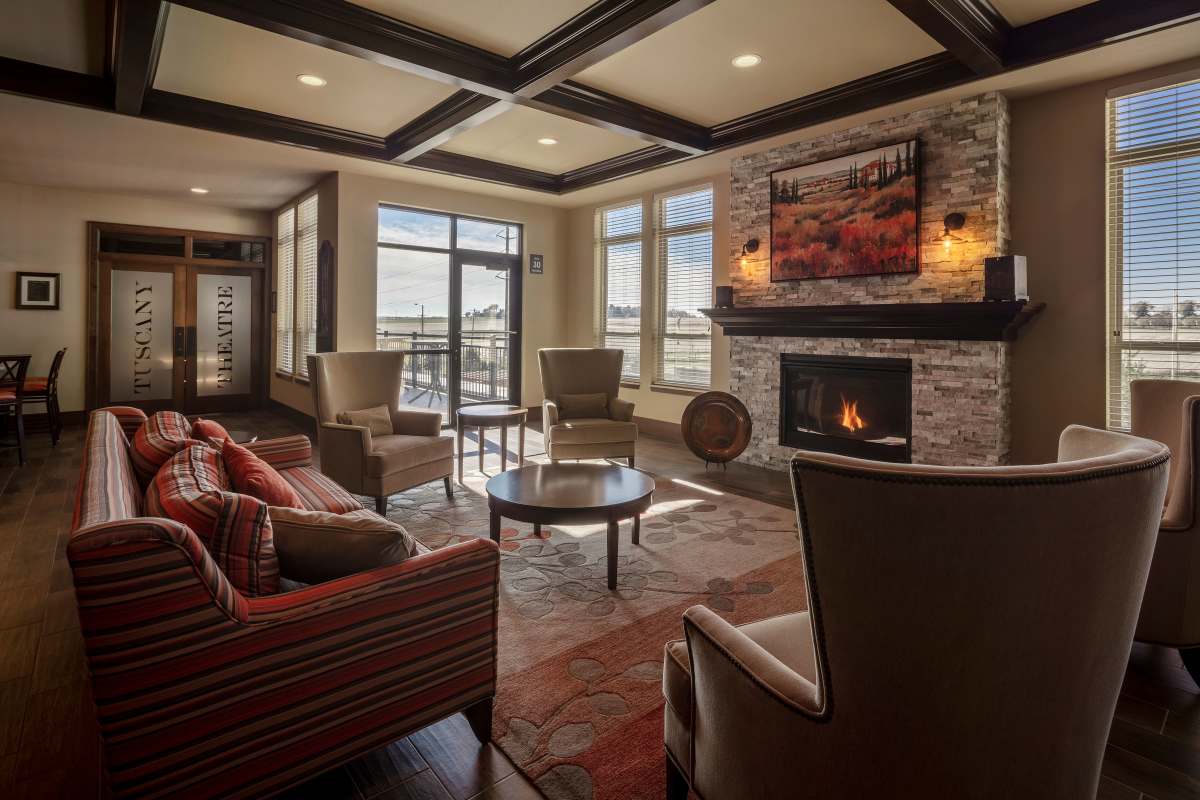 Stylish clubhouse lounge with cozy fireplace at The Tuscany On Pleasant View in Madison, Wisconsin