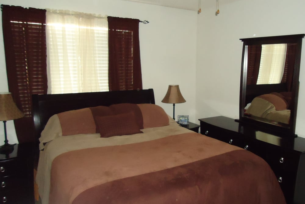 Cozy bedroom at Olympus Court Apartments in Bakersfield, California