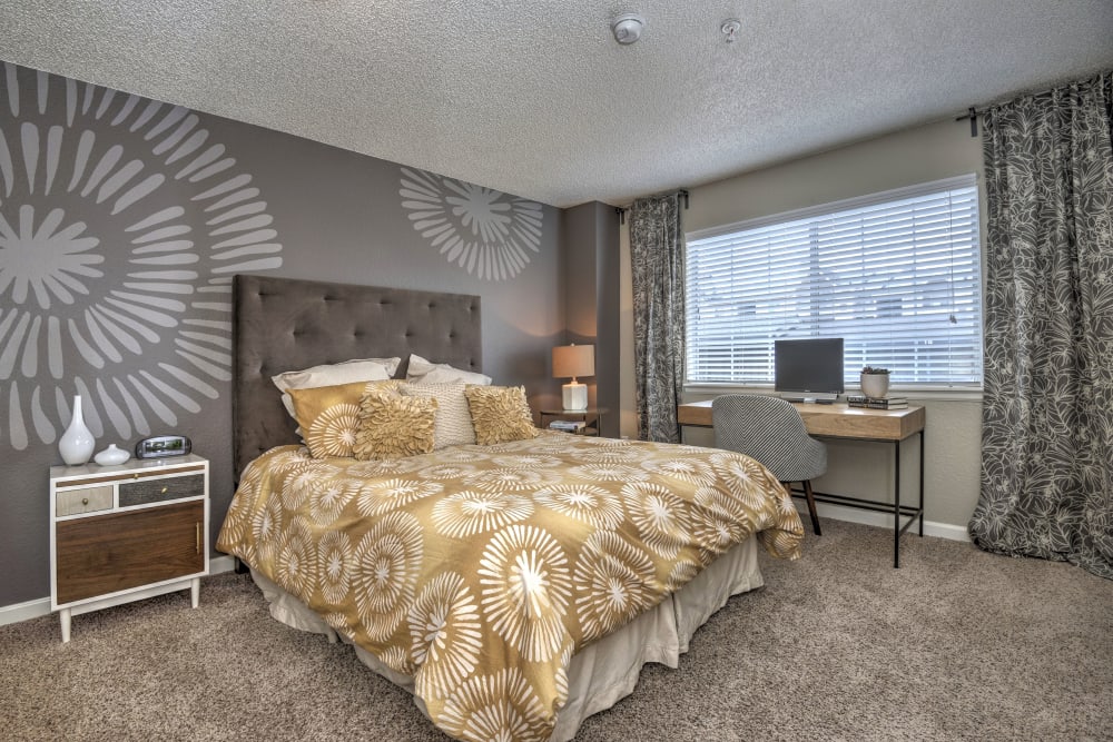 Master bedroom with a large window for natural lighting at Arapahoe Club Apartments in Denver, Colorado