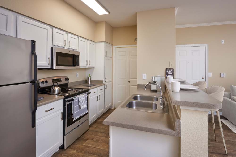 Kitchen with breakfast bar at Skyecrest Apartments in Lakewood, Colorado