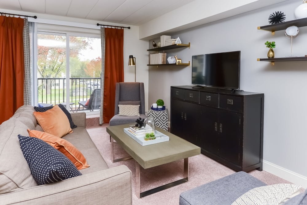 Living room opening onto a private balcony at Stonegate at Devon Apartments in Devon, Pennsylvania