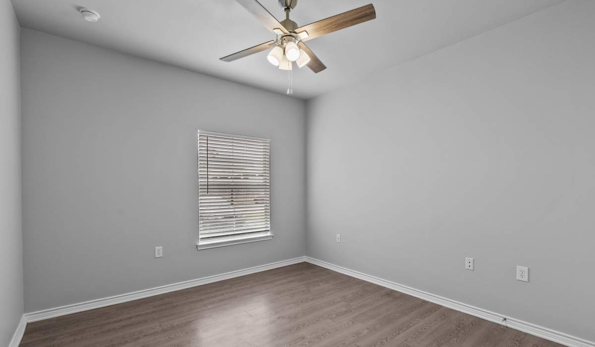 Unfurnished bedroom with fan at Stoneleigh Corpus Christi in Corpus Christi, Texas