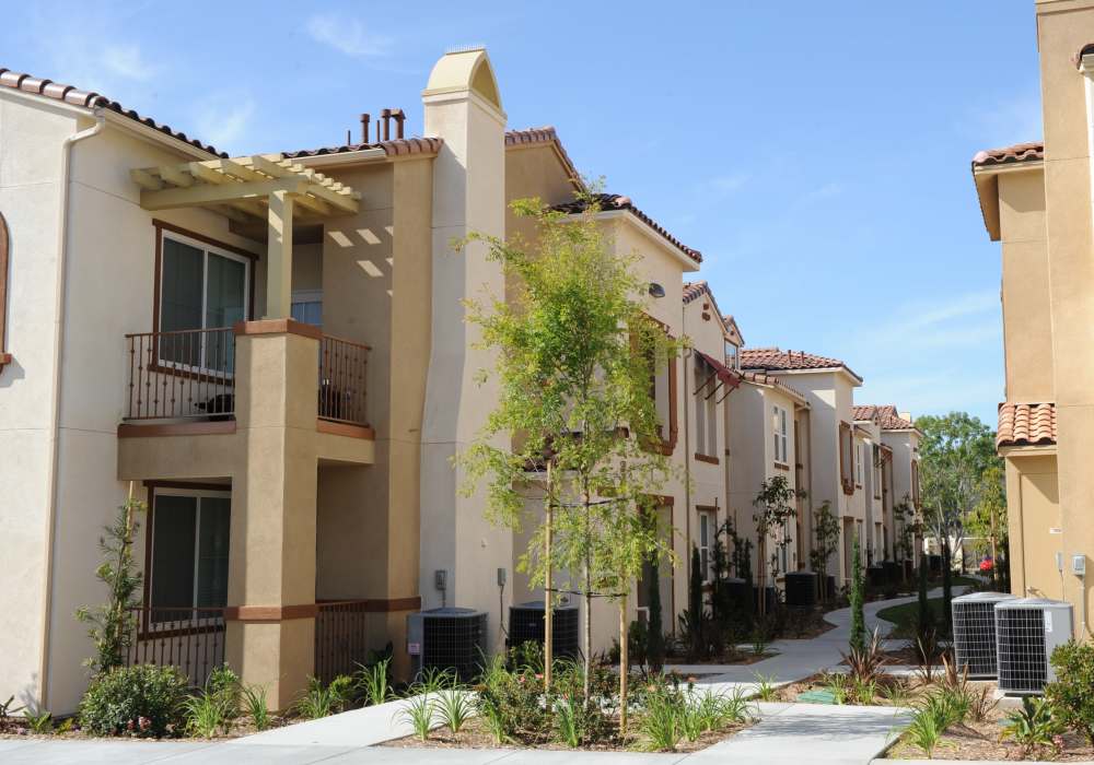 Charming outdoor space surrounded by lush landscaping and inviting balconies in a modern community setting at Cresta Bella in San Diego, California