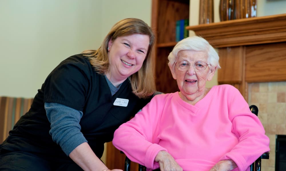 Caretaker and a resident smiling at Fair Oaks Health Care Center in Crystal Lake, Illinois