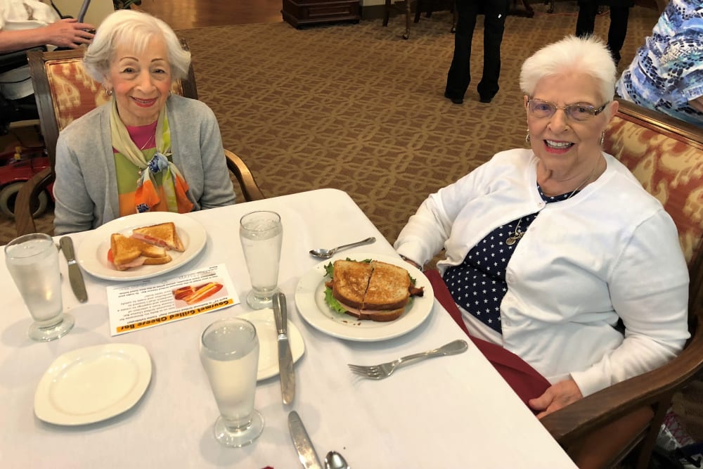 Resident friends having lunch at Merrill Gardens at Solivita Marketplace in Kissimmee, Florida. 