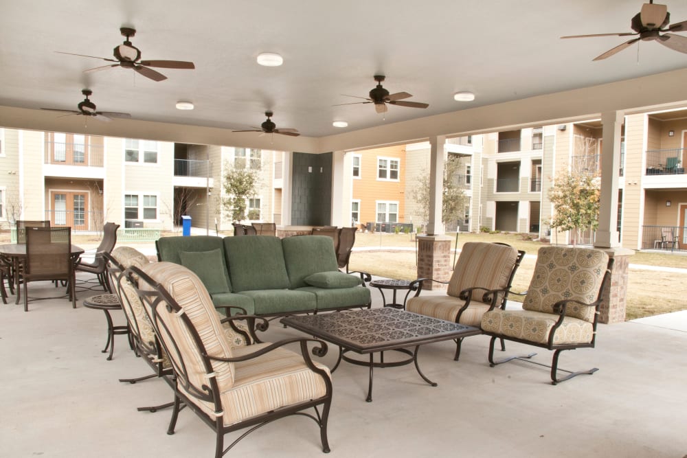 Outdoor seating on a covered patio at Mariposa at Bay Colony in Dickinson, Texas