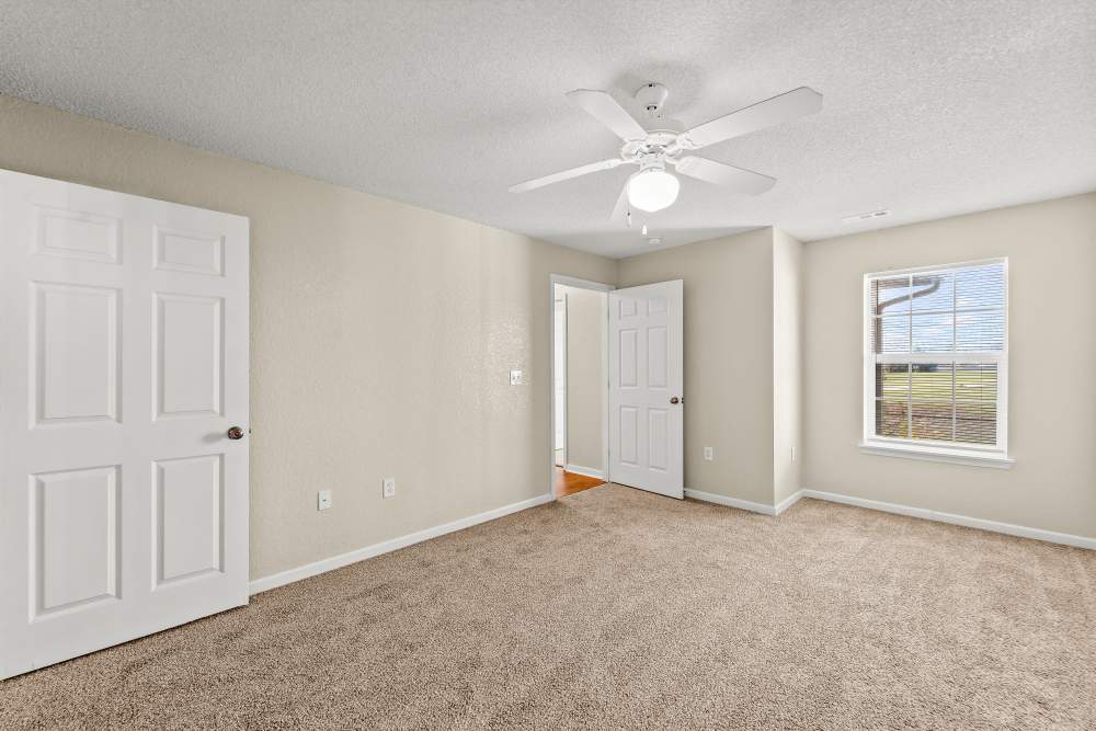 Carpet floored bedroom with ceiling fan at Callaway Village Phase II in Fulton, Missouri