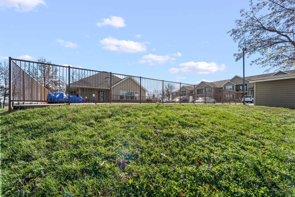 Lush green courtyard of apartments at Callaway Village Phase II in Fulton, Missouri