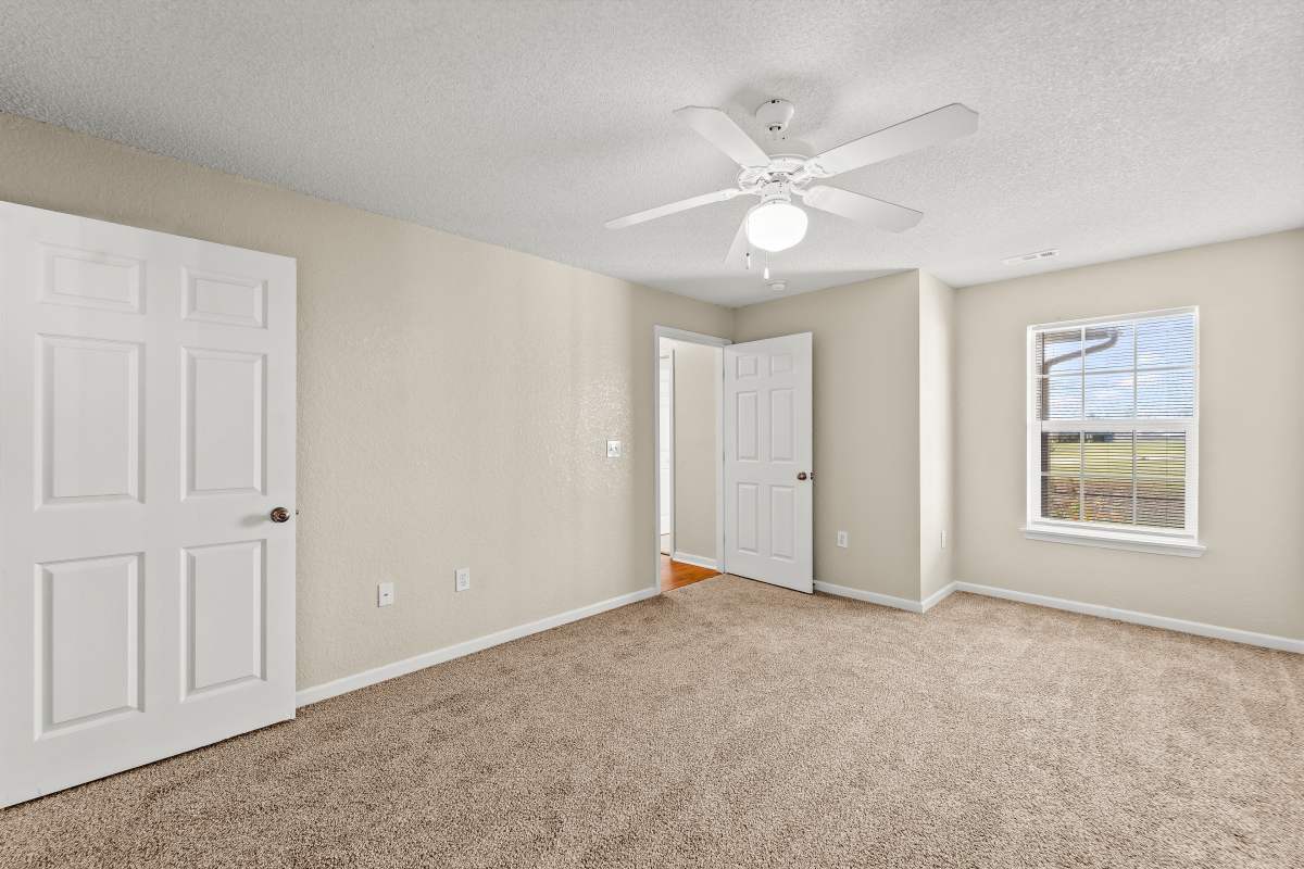 Unfurnished room with windows allowing sun rays at Callaway Village Apartments in Fulton, Missouri