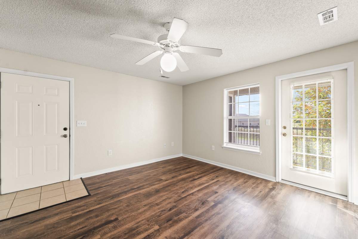 Well-lit living area with ceiling fan at Callaway Village Phase II in Fulton, Missouri