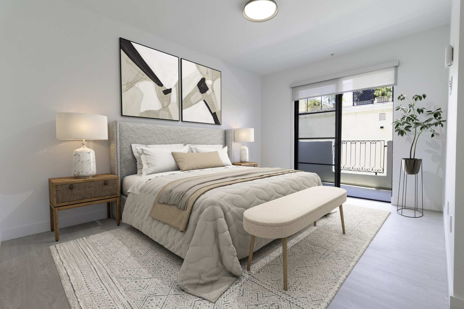 Minimalist bedroom with beige quilted bed, cushioned bench, abstract wall art, and balcony access at Luxe Villas in Brentwood, California 
