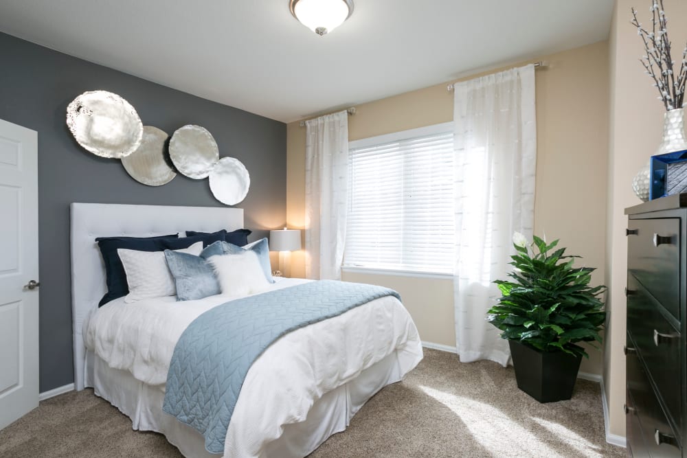 Large bedroom with a ceiling fan at Crestone Apartments in Aurora, Colorado