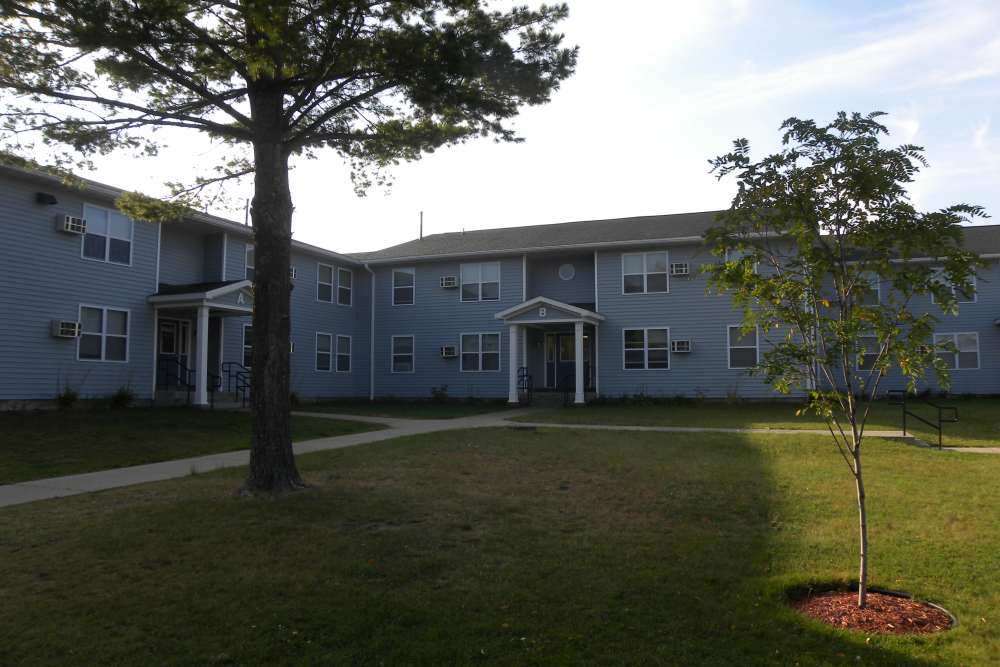 Apartments with greenery at Manistique Lakeview in Manistique, Michigan