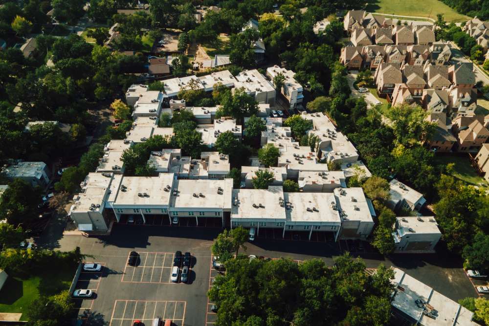 Charming community with lush landscaping and convenient parking at San Mateo Forest in Dallas, Texas.