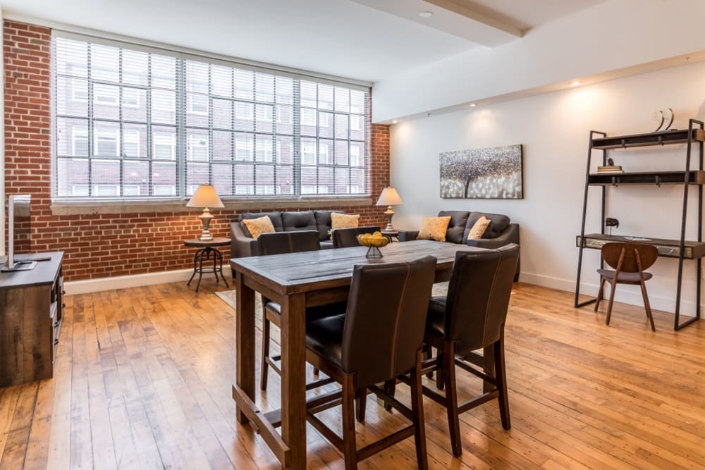 Model living and dining area with large windows at The Gallery Lofts in Winston Salem, North Carolina