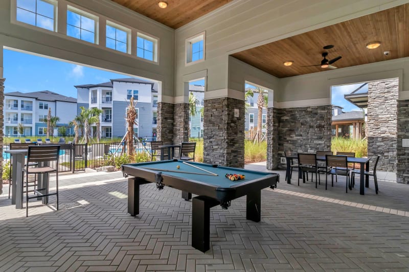 Outdoor lounge and pool table at Tapestry Westland Village in Jacksonville, Florida