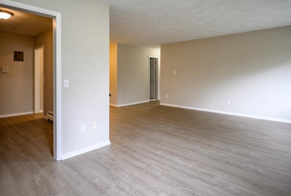 Living area with wood flooring at Country Manor Apartment Homes in Webster. NY