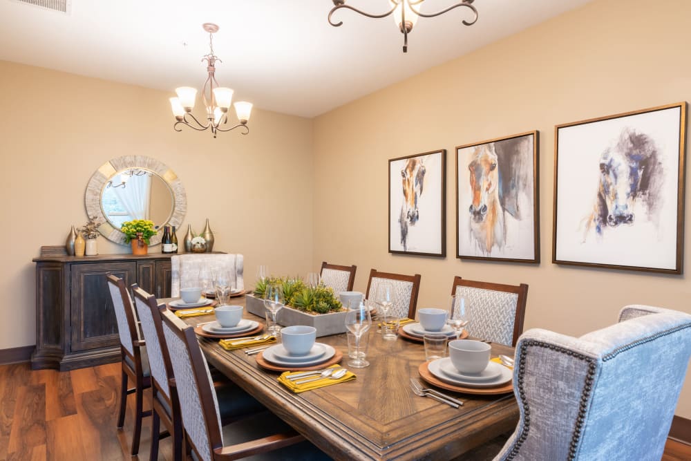 Dining table with pictures in the back at Heron Pointe Senior Living in Monmouth, Oregon. 