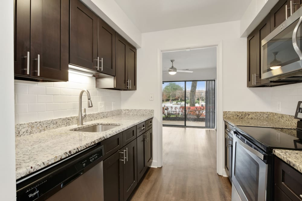 Model kitchen with espresso cabinetry at Annen Woods Apartments in Pikesville, Maryland