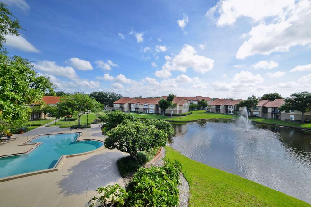 Swimming pool near a lake at Isles at East Millenia in Orlando, Florida