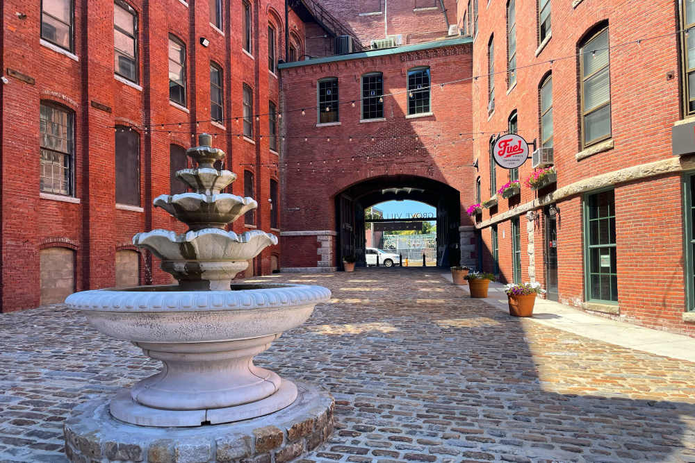 Fountain in brick courtyard at Grove Village Lofts in Worcester, Massachusetts