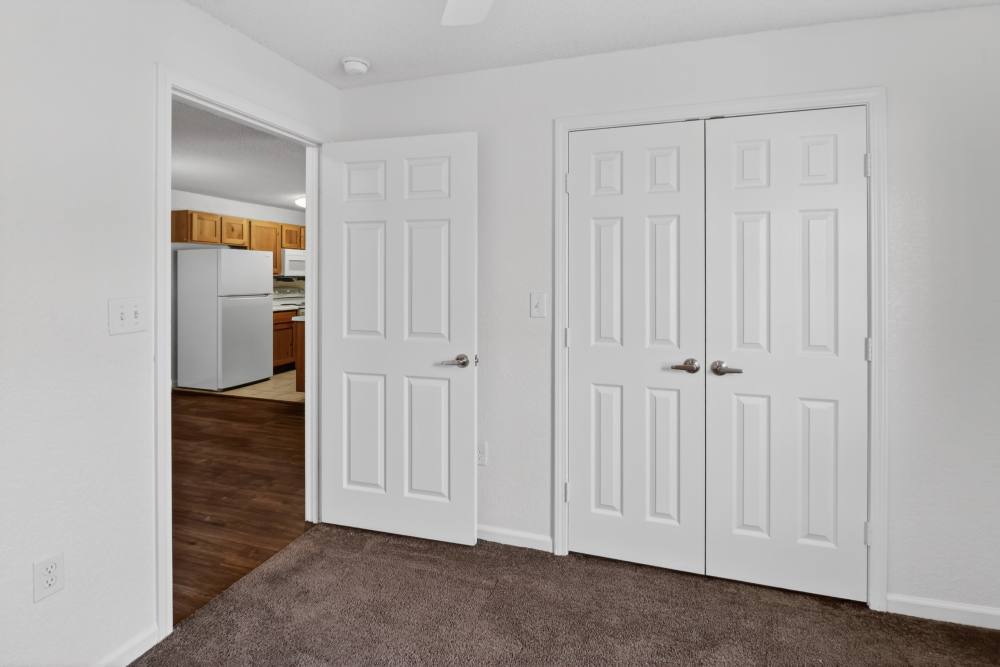Bedroom with closet and view to kitchen at Dunes Apartments in Seminole, Texas