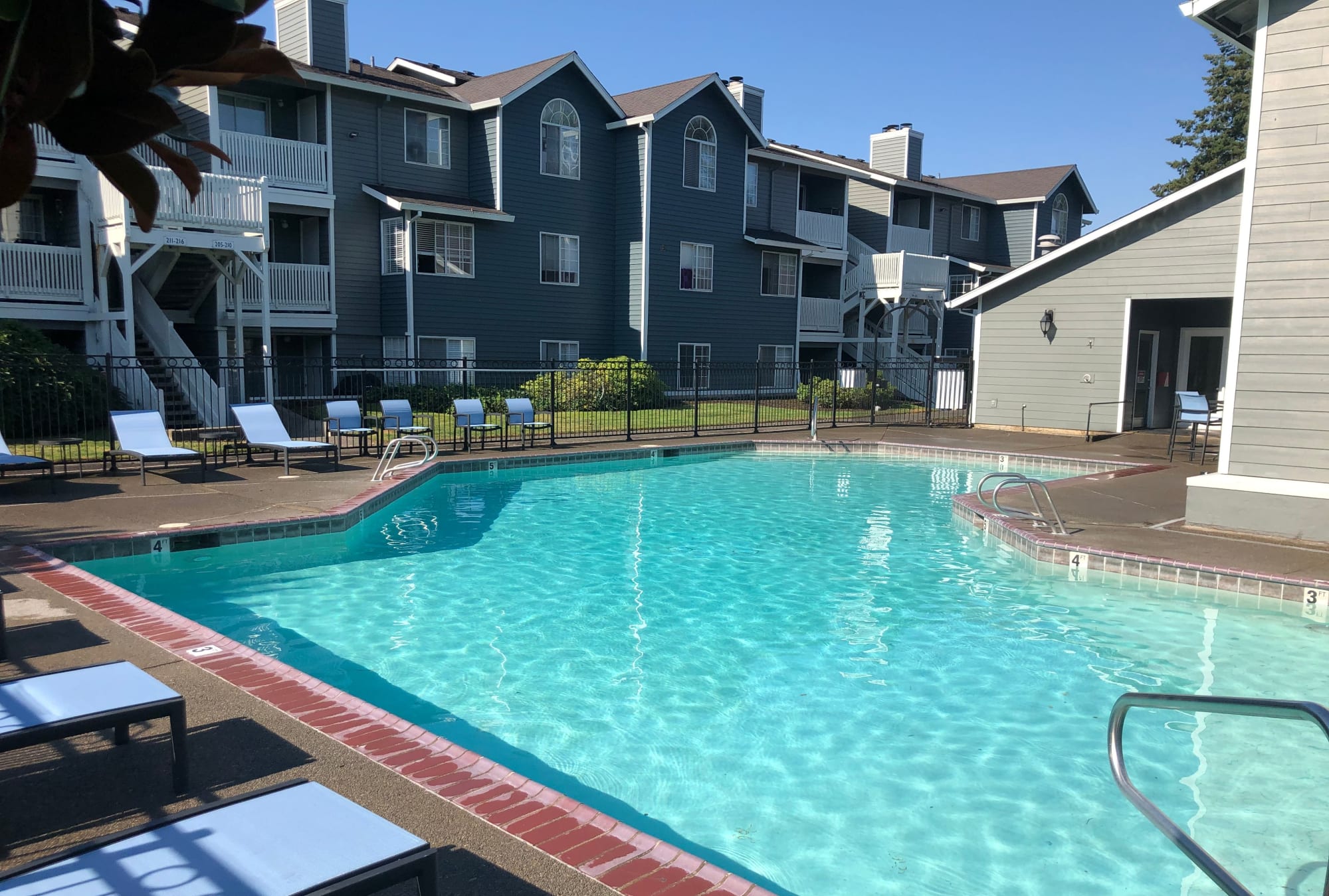 Beautiful pool area and lounge chairs at Walnut Grove Landing Apartments in Vancouver, WA