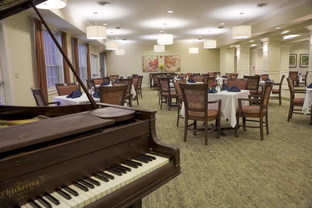 Dining room with piano at Harmony at Chantilly in Herndon, Virginia