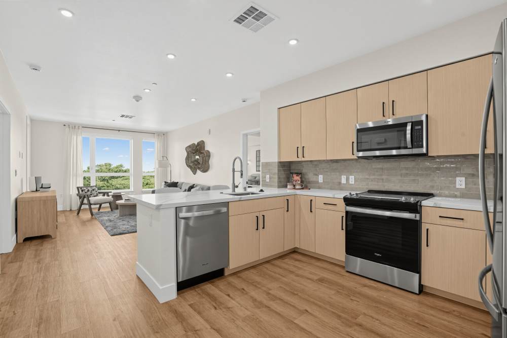 Modern kitchen with island and stainless-steel appliances at The Colton in Redwood City, California