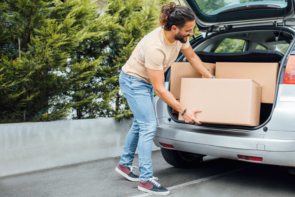 A customer moving a box from his car at Chateau Storage & Business Park in Maple Valley, Washington.