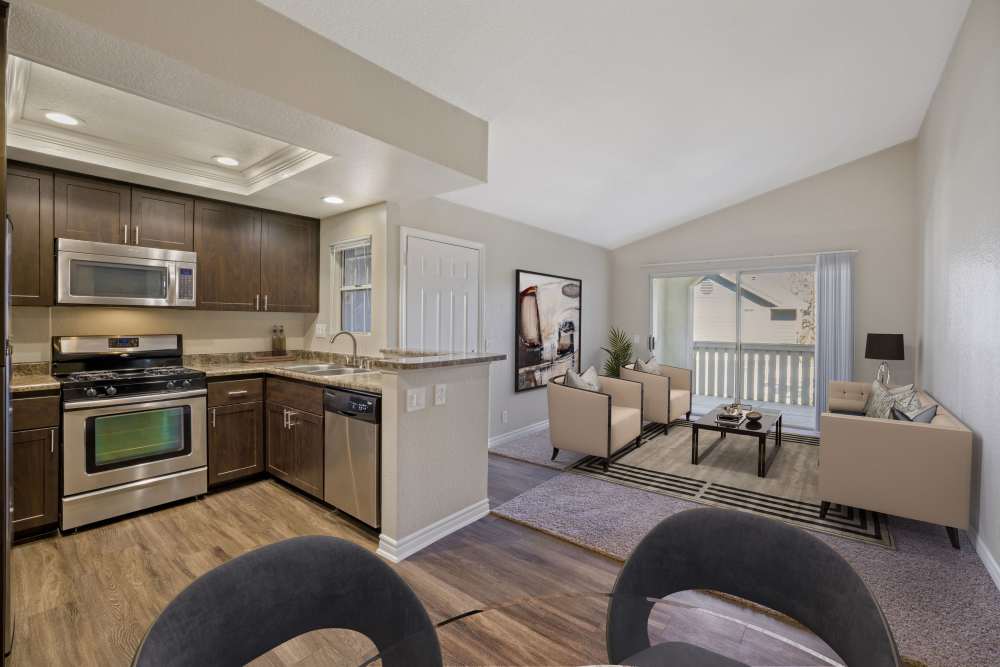 Espresso cabinets, stainless steel appliances, dining room and living room at Village Oaks in Chino Hills, California