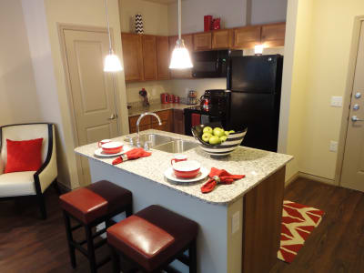 Gourmet kitchen with granite countertops and island at Anatole at City View in Lubbock, Texas
