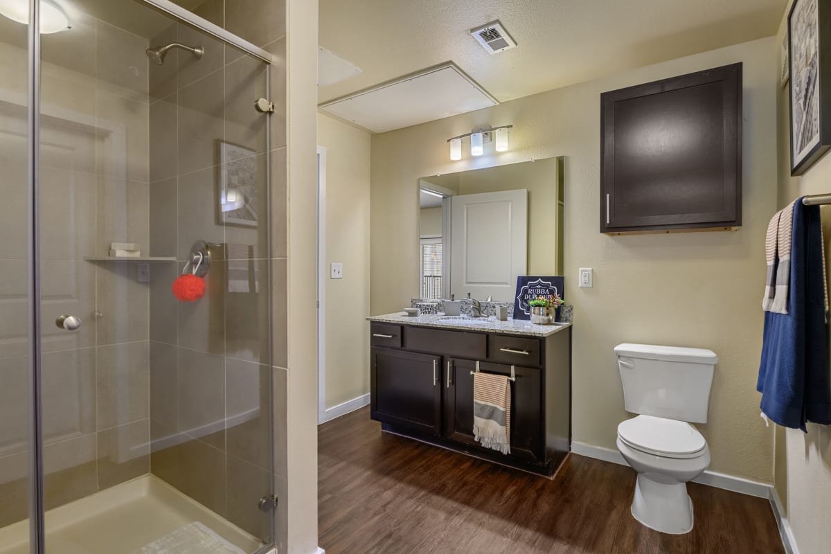 Modern bathroom with a glass shower at Marquis SoCo in Austin, Texas