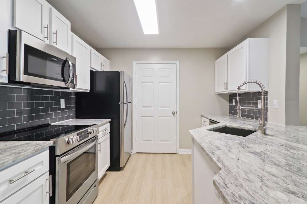 kitchen with appliances at The Waterford in Morrisville, North Carolina