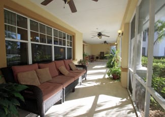 A porch with plenty of seating at Sunset Lake Village Senior Living in Venice, FL