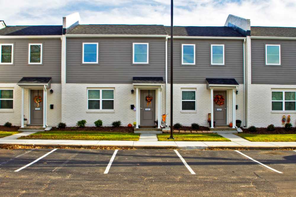 Exterior view of apartment building with street parking at Bell Diamond Manor in Norfolk, Virginia