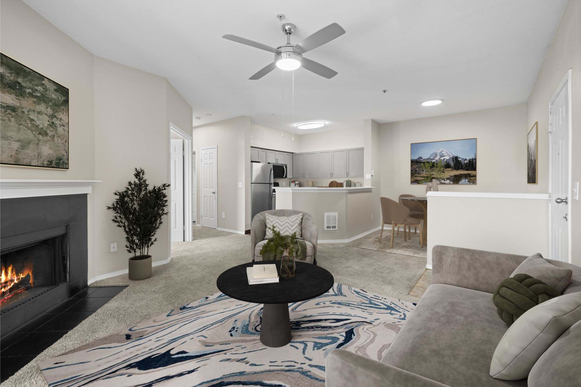 Livign room with large rug and fireplace at Wildreed Apartments in Everett, Washington