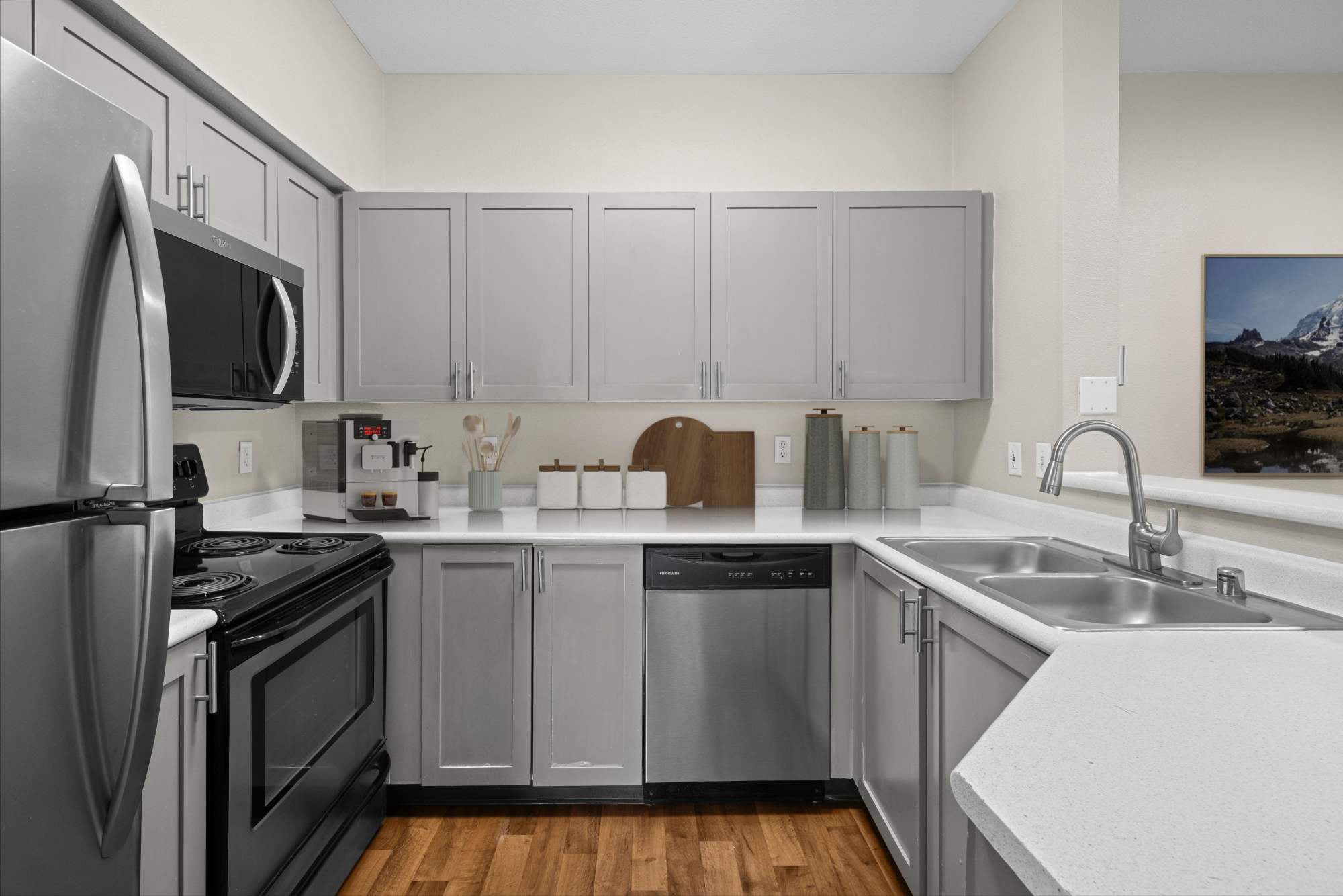 Spacious kitchen with white quartz counters at Wildreed Apartments in Everett, Washington