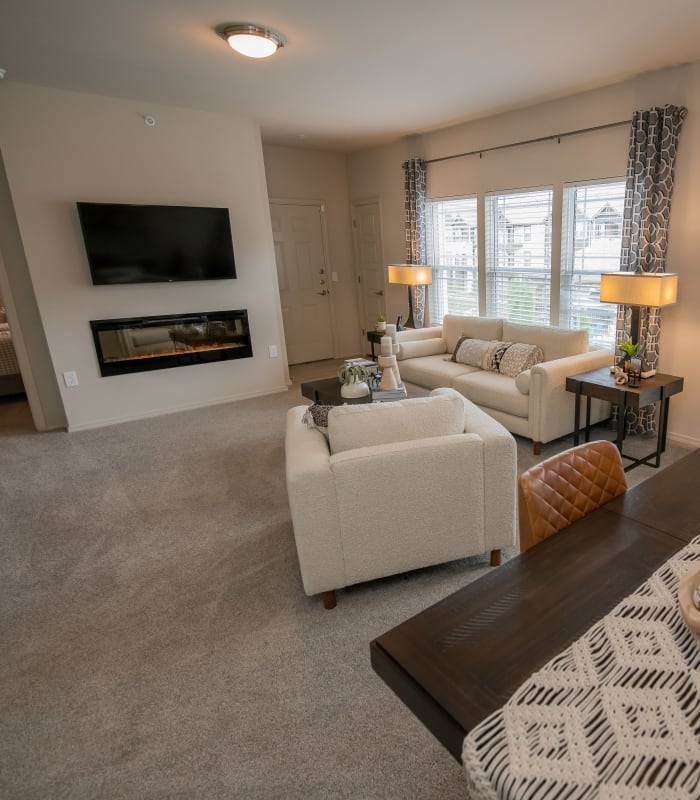 Spacious living room with large windows at Bend at New Road Apartments in Waco, Texas