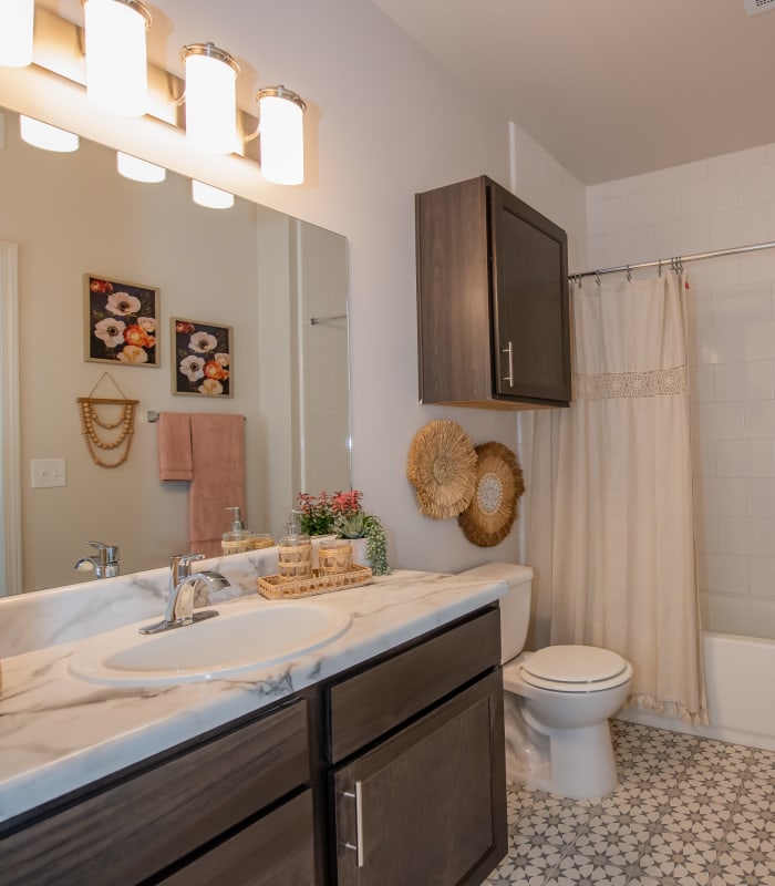 Bathroom with chic tile flooring at Adirondack in Independence, Missouri