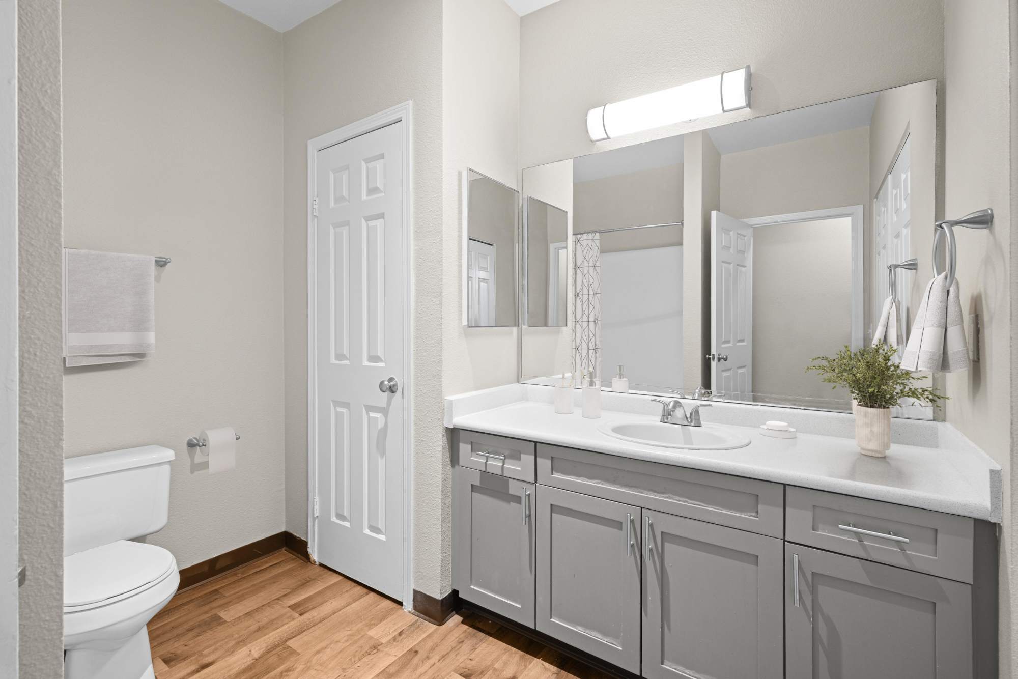 Master bathroom with grey cabinetry at Wildreed Apartments in Everett, Washington