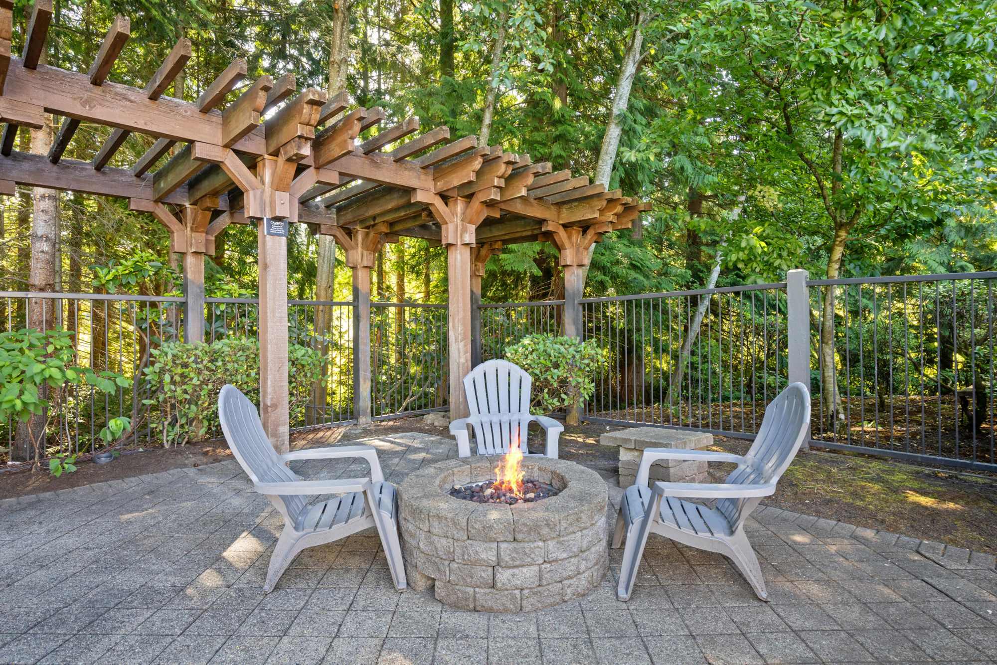 Fire pit lounge area near the pool at Wildreed Apartments in Everett, Washington