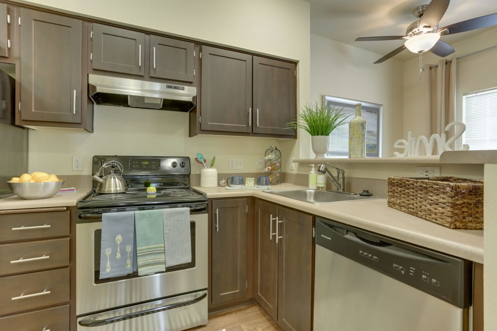 Kitchen with espresso cabinets at The Landings at Morrison Apartments in Gresham, Oregon