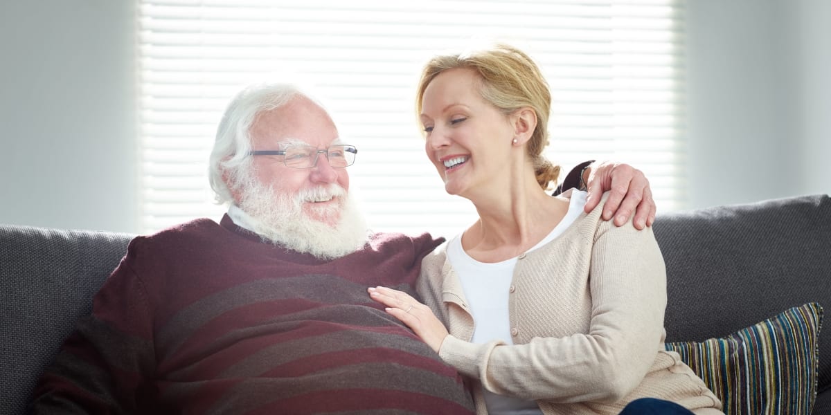Resident couple resting on a couch at Citrus Place in Riverside, California