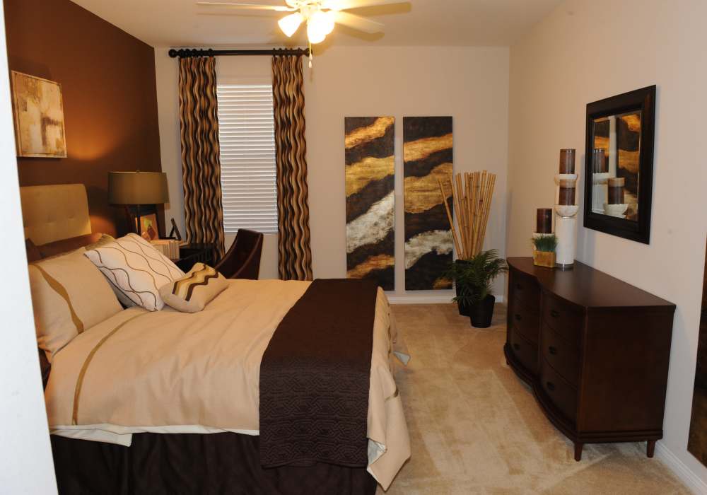 Model bedroom with ceiling fan at Cresta Bella in San Diego, California