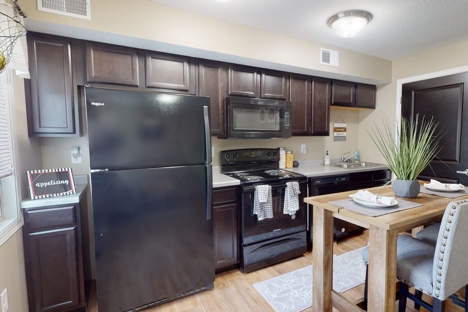 Kitchen in unit at The Quarters at Iowa City in Iowa City, Iowa