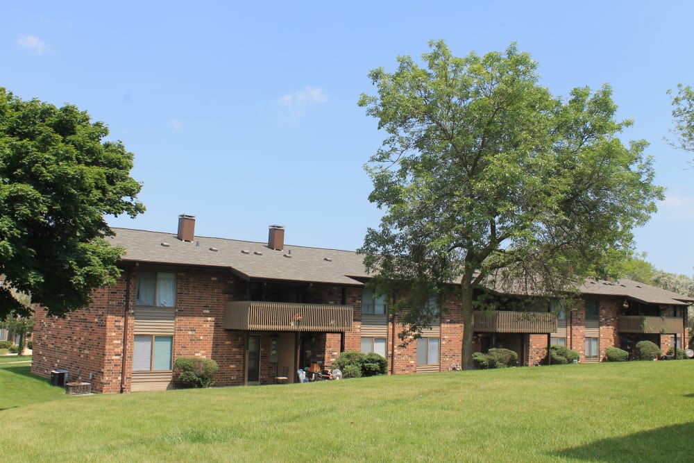 Apartments with beautiful landscaping at American Colony Apartments, in Greenfield