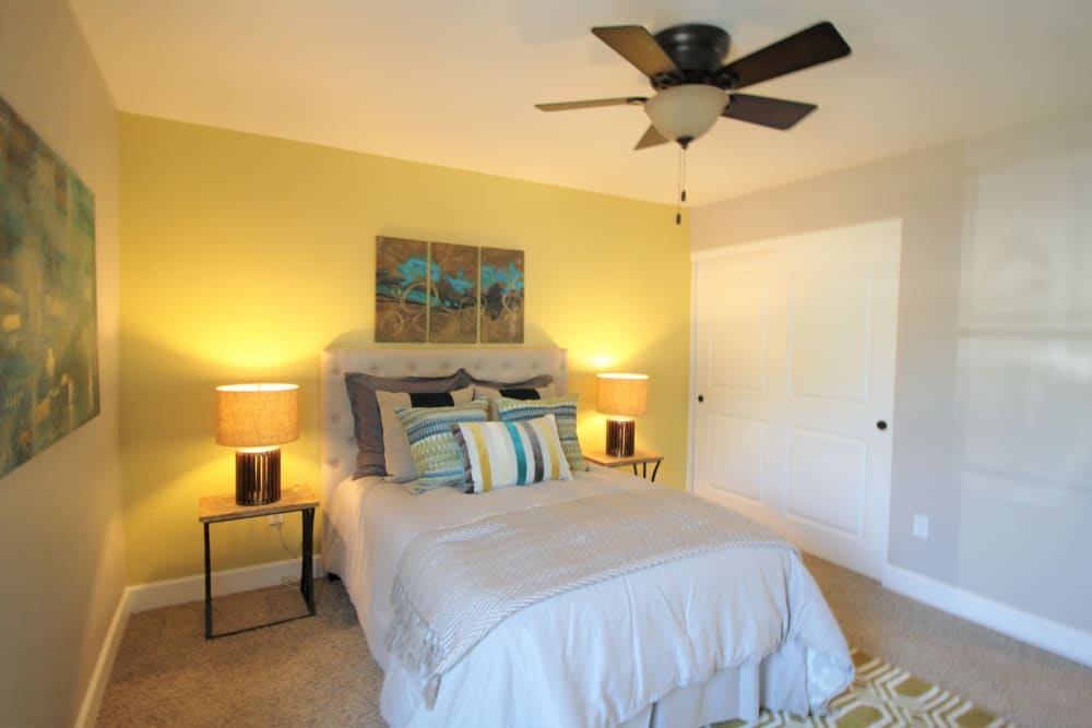 Model bedroom with ceiling fan at Ramblewood Apartment Homes in Fremont, California