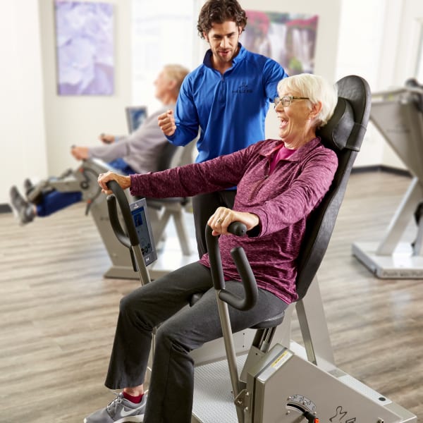 Resident working on HUR equipment with help from a caretaker at Quail Park at Shannon Ranch in Visalia, California